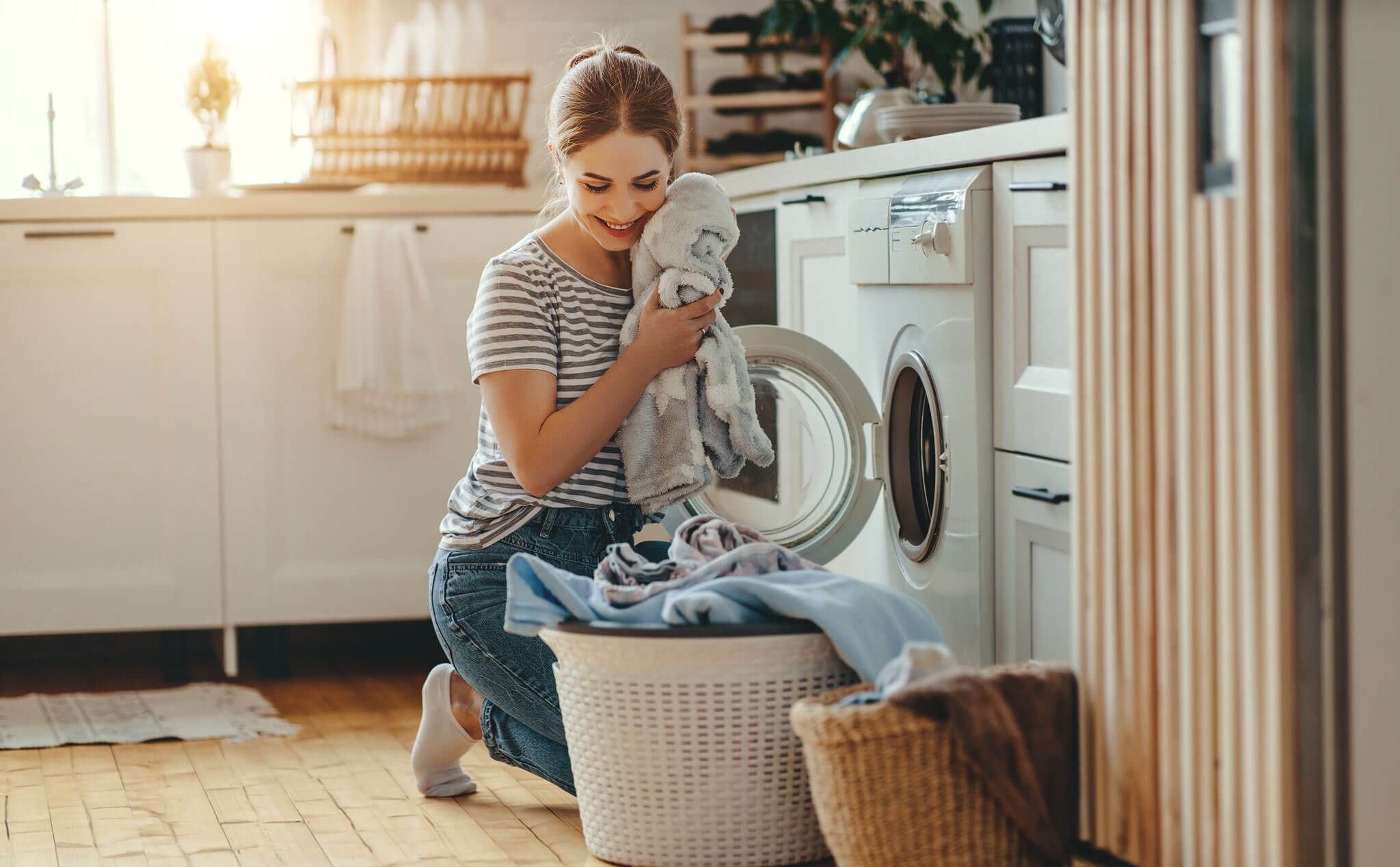 Woman loading washing machine