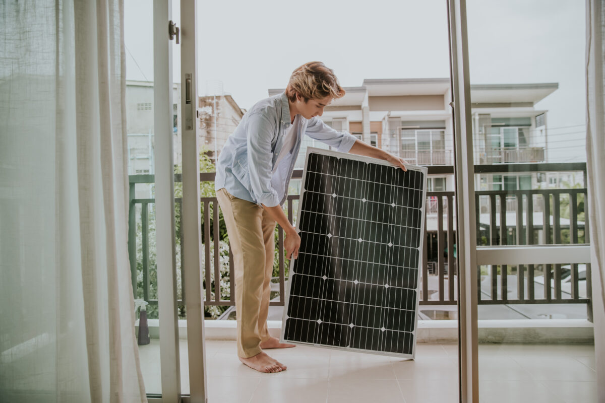 person is setting a solar panel